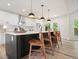 Kitchen island with stone countertop, white cabinets, pendant lighting, and seating for three at 3427 Mill Stream Sw Ln, Marietta, GA 30060