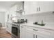 Bright kitchen with white cabinetry, stainless steel appliances, and a subway tile backsplash at 3427 Mill Stream Sw Ln, Marietta, GA 30060