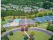 Aerial view showcasing a luxurious community clubhouse, pool, and tennis courts surrounded by lush greenery at 3988 Church View Ln, Suwanee, GA 30024