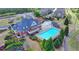 Aerial view of the clubhouse with a large swimming pool, sun deck, and well-maintained landscaping at 3988 Church View Ln, Suwanee, GA 30024