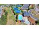 Aerial view showcasing the community's tennis courts, swimming pool, and clubhouse amidst lush greenery and homes at 3988 Church View Ln, Suwanee, GA 30024