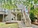 Multi-level deck with stairs leading to a brick patio creating a backyard oasis at 3988 Church View Ln, Suwanee, GA 30024