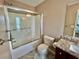 Bathroom featuring a shower over tub with glass doors, granite vanity and ceramic tile flooring at 3988 Church View Ln, Suwanee, GA 30024