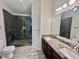 Modern bathroom with a dual sink granite countertop vanity and spacious glass shower with dark ceramic tiles at 3988 Church View Ln, Suwanee, GA 30024