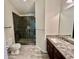 Modern bathroom featuring a sleek glass shower and granite countertop vanity with sink and spacious tile flooring at 3988 Church View Ln, Suwanee, GA 30024
