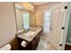 Bathroom featuring a granite countertop vanity, ceramic tile flooring and a large mirror at 3988 Church View Ln, Suwanee, GA 30024