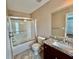 Bathroom featuring a shower over tub with glass doors, granite vanity and ceramic tile flooring at 3988 Church View Ln, Suwanee, GA 30024