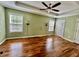 Spacious bedroom featuring hardwood floors, tray ceilings and a ceiling fan at 3988 Church View Ln, Suwanee, GA 30024