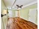 Spacious bedroom featuring hardwood floors, tray ceilings and a ceiling fan at 3988 Church View Ln, Suwanee, GA 30024
