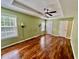 Spacious bedroom featuring hardwood floors, tray ceilings and a ceiling fan at 3988 Church View Ln, Suwanee, GA 30024