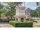 Community entrance featuring brick architecture, manicured landscaping, and clear signage for 'Suwanee Station' at 3988 Church View Ln, Suwanee, GA 30024
