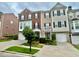Charming brick and siding townhome featuring a well-manicured front yard and attached two-car garage at 3988 Church View Ln, Suwanee, GA 30024