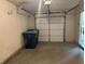 Spacious two-car garage with a white door and ample room for storage and parking at 3988 Church View Ln, Suwanee, GA 30024