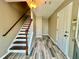 Inviting entryway with stylish wood-look tile flooring and staircase with white railings at 3988 Church View Ln, Suwanee, GA 30024