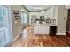Kitchen view with hardwood floors, stainless steel appliances and white cabinets at 3988 Church View Ln, Suwanee, GA 30024