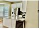 Bright kitchen boasts stainless steel appliances, granite countertops and a wine cooler at 3988 Church View Ln, Suwanee, GA 30024