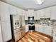 Well-lit kitchen with stainless steel appliances, tile backsplash, and ample cabinet space at 3988 Church View Ln, Suwanee, GA 30024