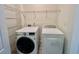 Laundry room with full-size washer, dryer, and shelving at 3988 Church View Ln, Suwanee, GA 30024