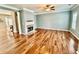 Bright living room with hardwood floors, fireplace and an open-concept design at 3988 Church View Ln, Suwanee, GA 30024