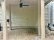 Charming covered brick patio with ceiling fan offering a cozy retreat for outdoor living at 3988 Church View Ln, Suwanee, GA 30024