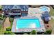 Aerial view showcasing a large swimming pool with sun loungers, a splash pool, and lush landscaping at 3988 Church View Ln, Suwanee, GA 30024