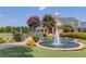 Beautiful water feature with a fountain, stone bridge, and vibrant landscaping in a serene community setting at 3988 Church View Ln, Suwanee, GA 30024
