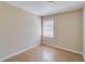 Neutral-toned bedroom with refinished floors and bright light from the single window at 80 Crystal River Dr, Riverdale, GA 30274