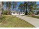 This single story home features a long driveway and beautiful lawn at 80 Crystal River Dr, Riverdale, GA 30274