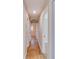 A bright hallway features wood floors and white doors leading to various rooms in the home at 80 Crystal River Dr, Riverdale, GA 30274