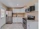 Updated kitchen with stainless steel appliances, white cabinetry, and granite countertops at 80 Crystal River Dr, Riverdale, GA 30274