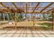 Covered patio with a view of the wooded backyard and adjacent storage building at 80 Crystal River Dr, Riverdale, GA 30274
