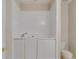 Enclosed bathroom with toilet and sink with white cabinets offering a simple and functional design at 124 Camry Ln, Grayson, GA 30017