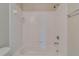 Clean white bathtub with tiled shower walls at 124 Camry Ln, Grayson, GA 30017
