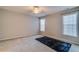 Bright bedroom with neutral carpet, ceiling fan, and well-lit windows, offering a comfortable and serene space at 124 Camry Ln, Grayson, GA 30017