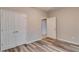 Bedroom featuring modern flooring, closet doors, and access to additional rooms, creating a spacious and functional layout at 124 Camry Ln, Grayson, GA 30017