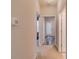 Bright hallway featuring doorways, carpet flooring, and views of sunlit rooms, creating an inviting transition space at 124 Camry Ln, Grayson, GA 30017