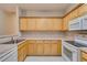 Traditional kitchen with ample cabinetry, white appliances, and light countertops, offering a clean and functional space at 124 Camry Ln, Grayson, GA 30017