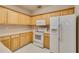 Traditional kitchen with ample cabinetry, white appliances, and light countertops, offering a clean and functional space at 124 Camry Ln, Grayson, GA 30017