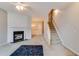 Open living room with fireplace, staircase, and adjoining dining area at 124 Camry Ln, Grayson, GA 30017
