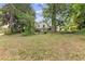 Large backyard features mature trees and landscaping with a wooden bench at 5128 Lavista Rd, Tucker, GA 30084