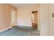Bedroom with light pink wallpaper and turquoise carpet, featuring a closet and doorway at 5128 Lavista Rd, Tucker, GA 30084