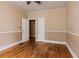 Bedroom with wood floors, two doors, and a fan at 5128 Lavista Rd, Tucker, GA 30084