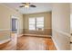 Bedroom featuring a fan, wood floors, a window, and a doorway leading to another room at 5128 Lavista Rd, Tucker, GA 30084