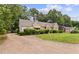Charming stone home featuring a well-maintained lawn and mature landscaping at 5128 Lavista Rd, Tucker, GA 30084