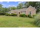 Charming stone home featuring a well-maintained lawn and mature landscaping at 5128 Lavista Rd, Tucker, GA 30084