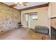 Living room featuring a stone fireplace, wooden ceiling beams and access to multiple rooms at 5128 Lavista Rd, Tucker, GA 30084