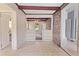A living room featuring a wooden beamed ceiling and a doorway to another room at 5128 Lavista Rd, Tucker, GA 30084