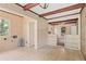 A living room featuring a wooden beamed ceiling and a doorway to another room at 5128 Lavista Rd, Tucker, GA 30084