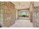 Sunroom featuring brick walls and large windows with a view of the green landscape at 5128 Lavista Rd, Tucker, GA 30084