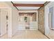 Sunroom featuring stone accent wall, wood beams, and built in shelves at 5128 Lavista Rd, Tucker, GA 30084